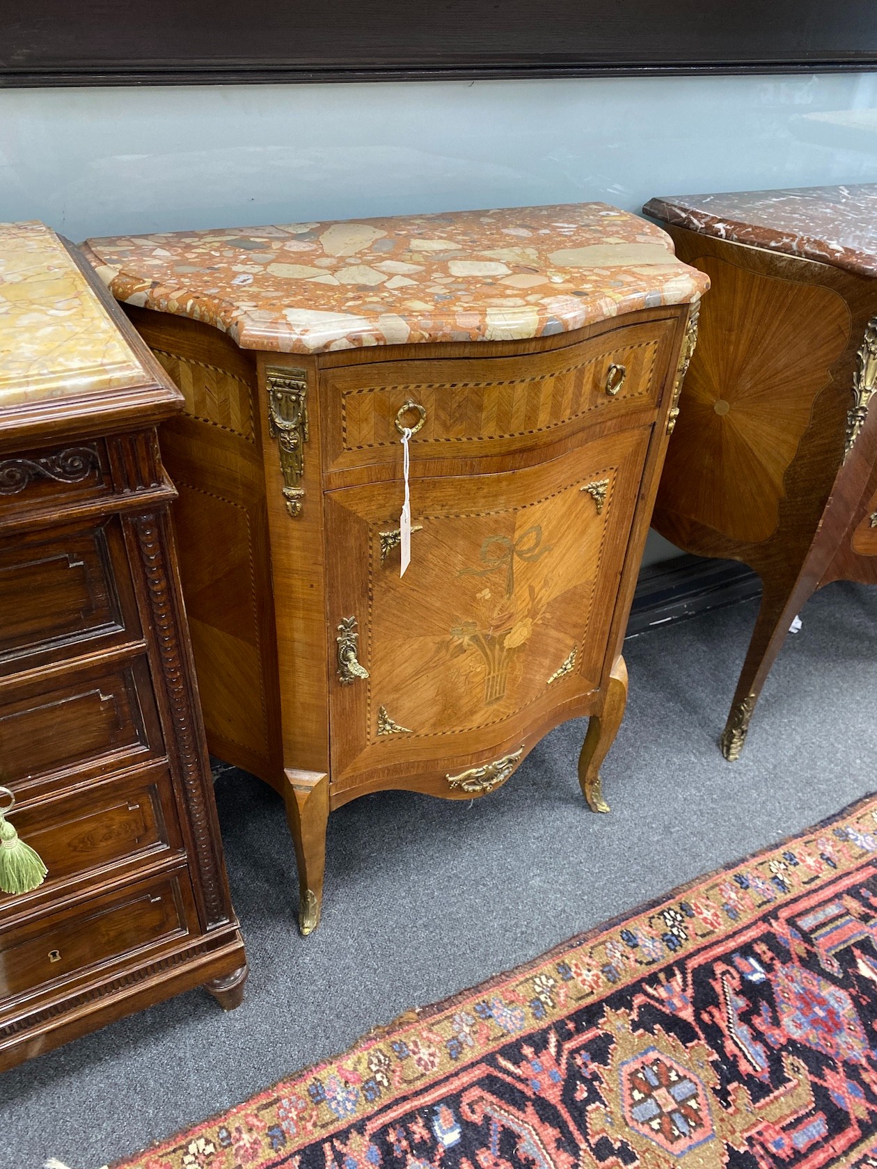 A Louis XVI style marquetry inlaid kingwood marble top serpentine cabinet, width 67cm, depth 35cm, height 81cm